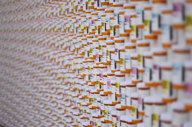 Image: The Colorado Department of Human Services unveiled a memorial wall made of 4,200 prescription bottles at Civic Center Park on Monday, May 14.