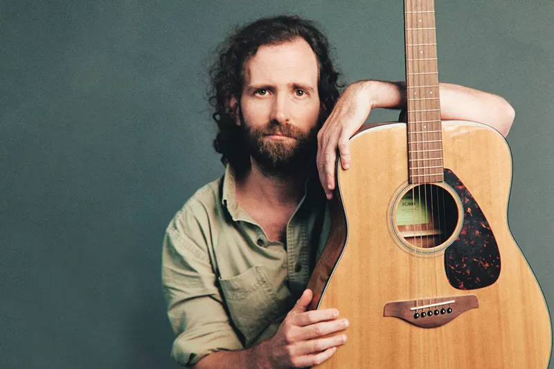 Image: a man with a guitar
