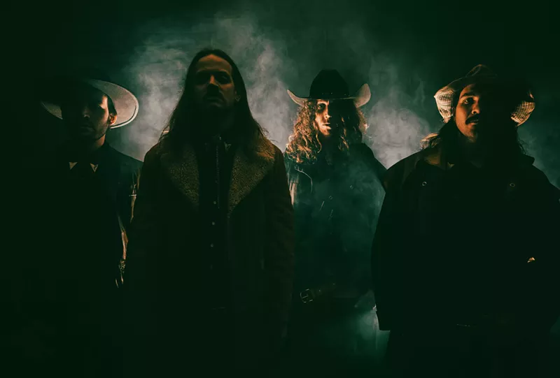 Image: band members wearing western wear for a photo shoot