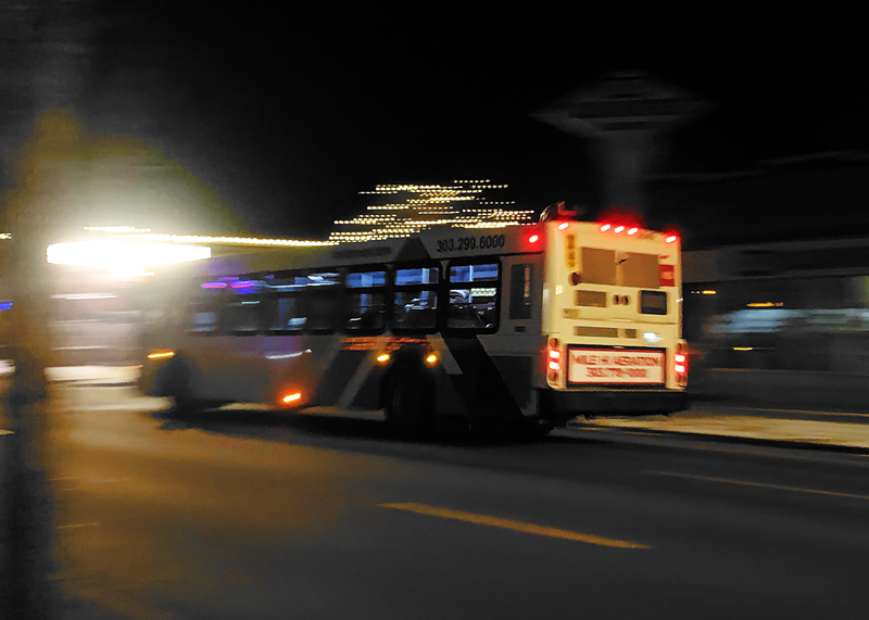 Image: An RTD bus drives down a road at night