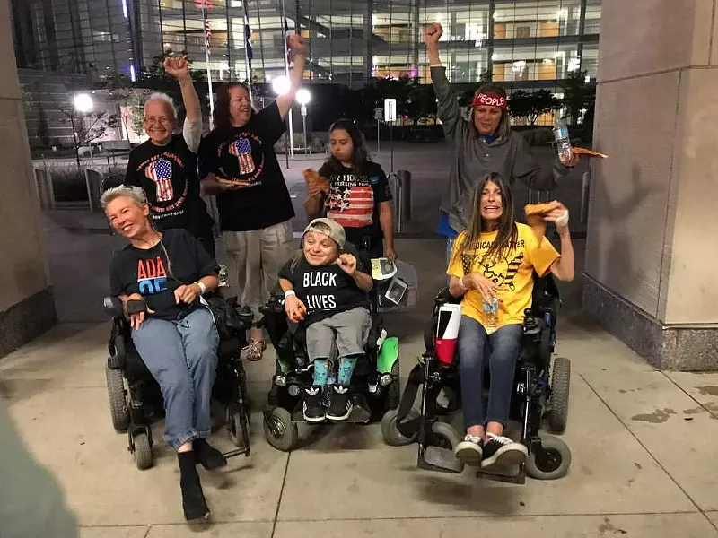 Image: ADAPT shut down Senator Cory Gardner's office for three days last week, demanding he vote against the Republican repeal of the Affordable Care Act. In the center of this photo is Kalyn Heffernan.