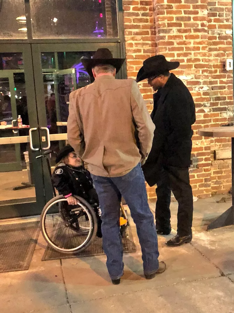 Image: Kalyn Heffernan, Brad Buchanan and Albus Brooks discuss accessibility and the arts outside a Meow Wolf party on January 4.