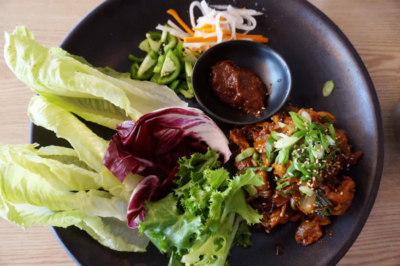 Image: Spicy pork ssam at Ssäm BBQ comes with a variety of leafy greens to add cool, crisp texture.