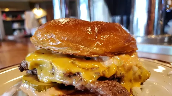 A tantalizing hamburger dripping with cheese