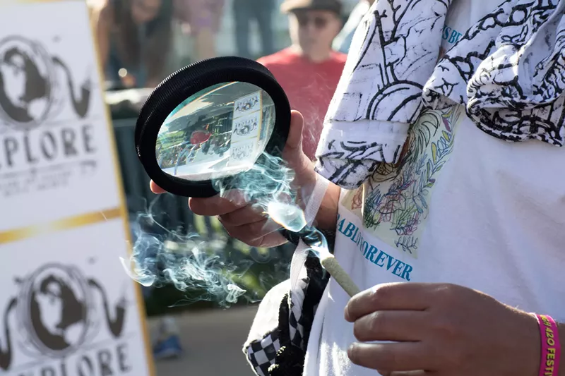 Image: Lighting a joint with a magnifying glass
