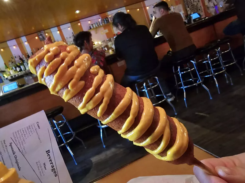 Image: A corndog being held up in Sputnik