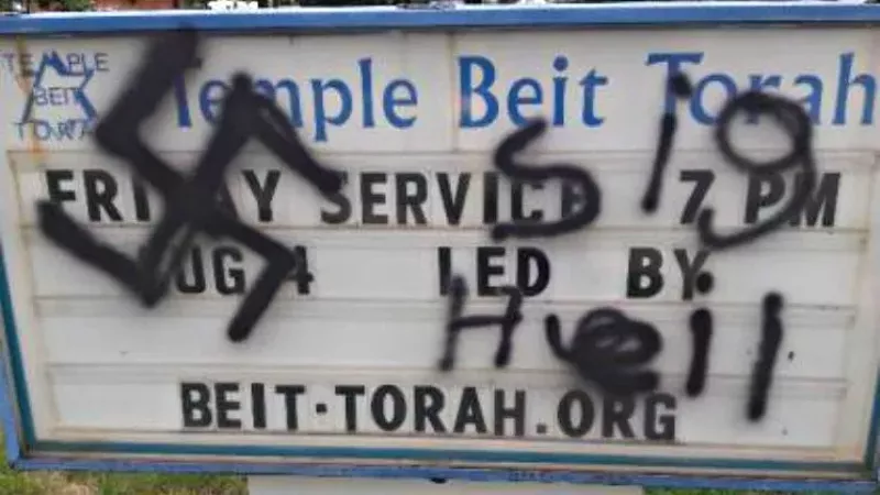 Image: Vandalism on the sign of Temple Beit Torah in Colorado Springs circa August 2017.