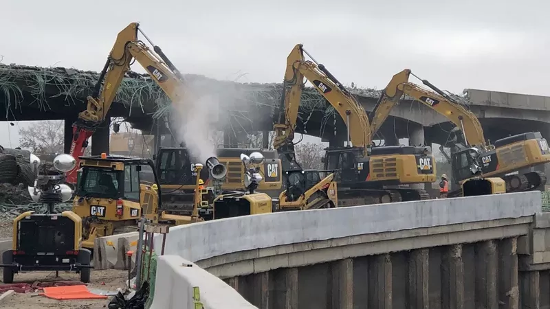 Image: This photo from May 22 shows misting cannons being used to wet dust during the demolition of the old Interstate 70 viaduct.