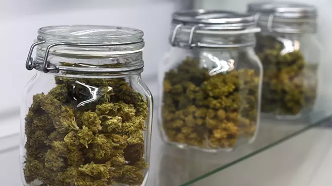 jars of marijuana buds on shelf