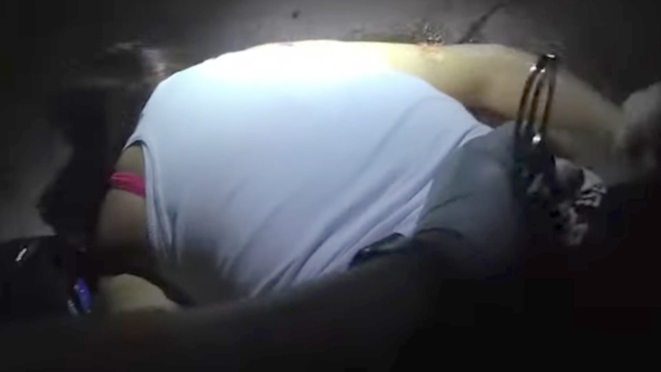 A screen capture from body-camera footage of the shooting shows a police officer cuffing a motionless Jamie Fernandez.