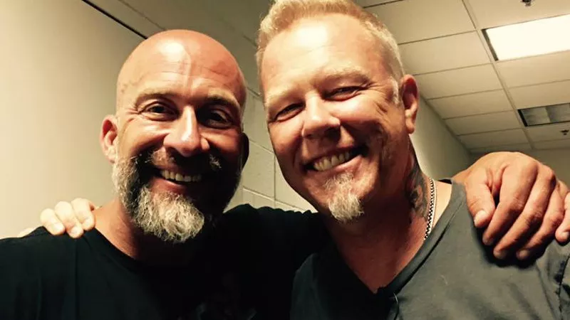 Image: KBPI's Willie B strikes a pose alongside Metallica's James Hetfield.