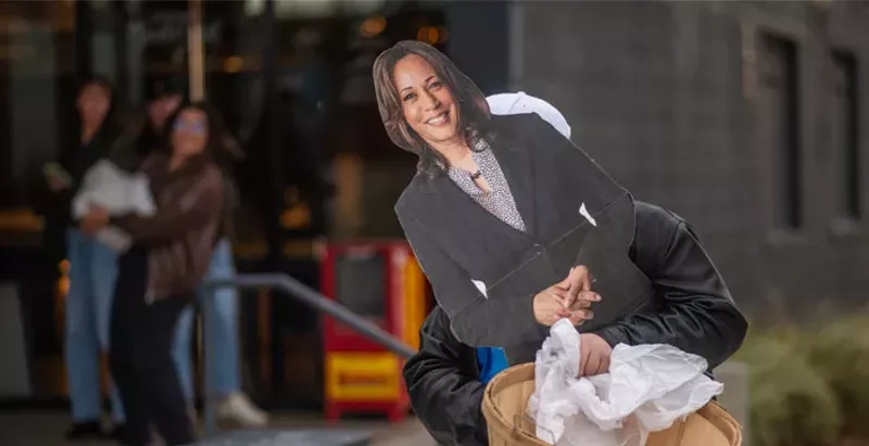 Image: cardboard cutout of Kamala being carried out