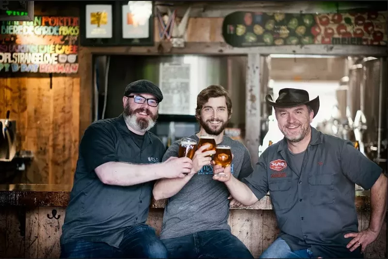 Image: Scott Witsoe (left), Tyler Bies (center) and Tim Myers toast to a new arrangement.