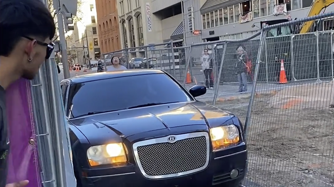 Black Chrysler 300 with fake Bently sign drives through fence