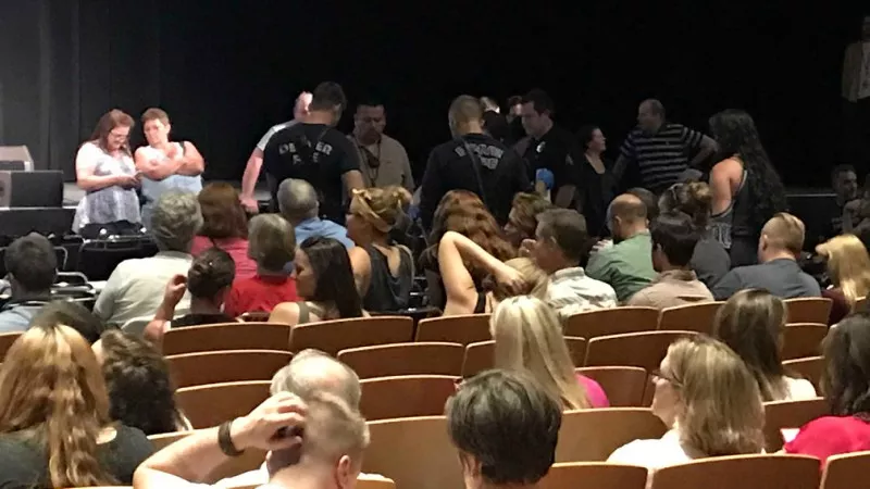 Image: Emergency personnel treat a woman who collapsed during the Pod Save America live show in Denver.