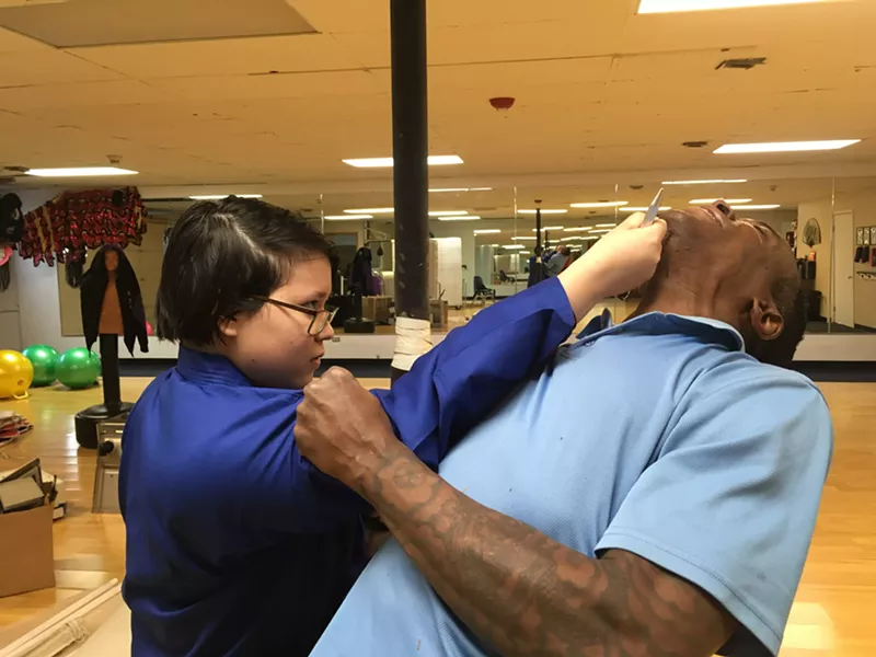 Image: A student pops Master Clarke in one of his Women Learn to Kick Ass classes.