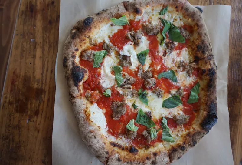 Image: A margharita pizza with added sausage at Pizzeria Lui.