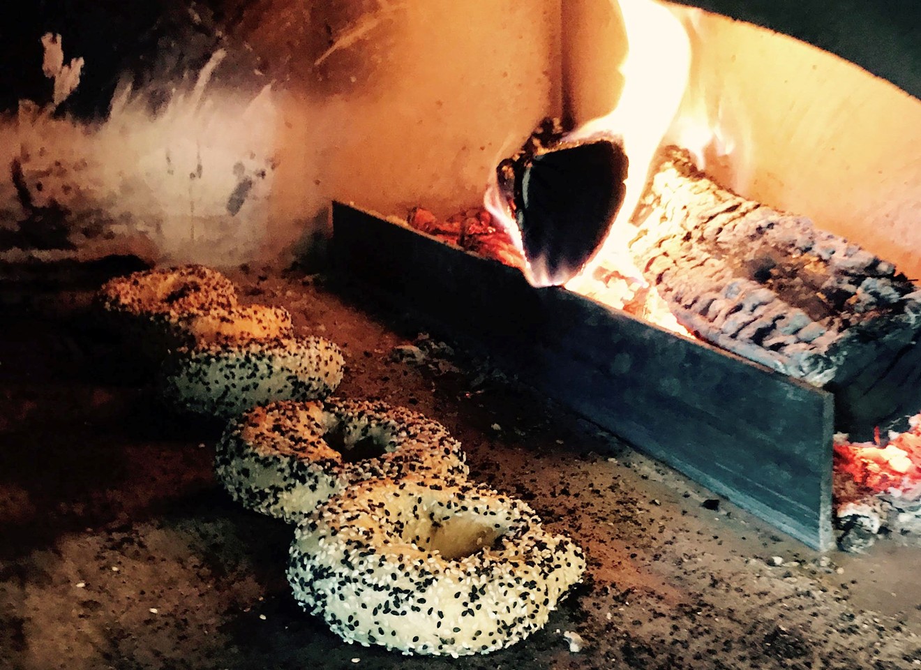 Montreal-style bagels bake in the wood-burning oven at Woodgrain.