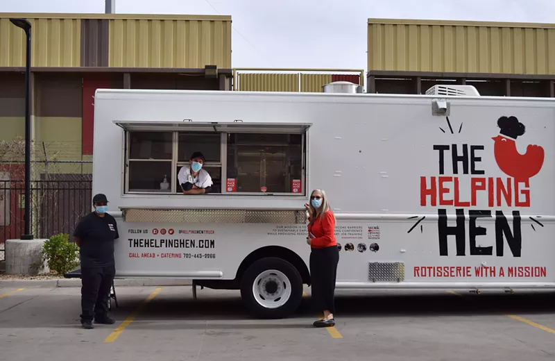 Image: Executive director Julie Stone, intern Faith Lippe and chef Bryan Machesky pose in front of the Helping Hen, a new food truck run by nonprofit Work Options for Women (WOW).