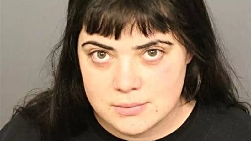 Image: A booking photo of Madeline Cramer.