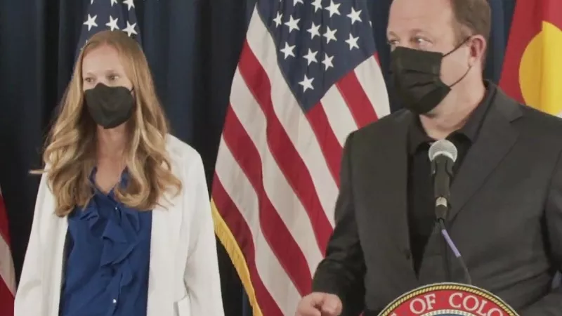 Image: Governor Jared Polis and lead Colorado epidemiologist Dr. Rachel Herlihy at the outset of a December 2 press conference about COVID-19.