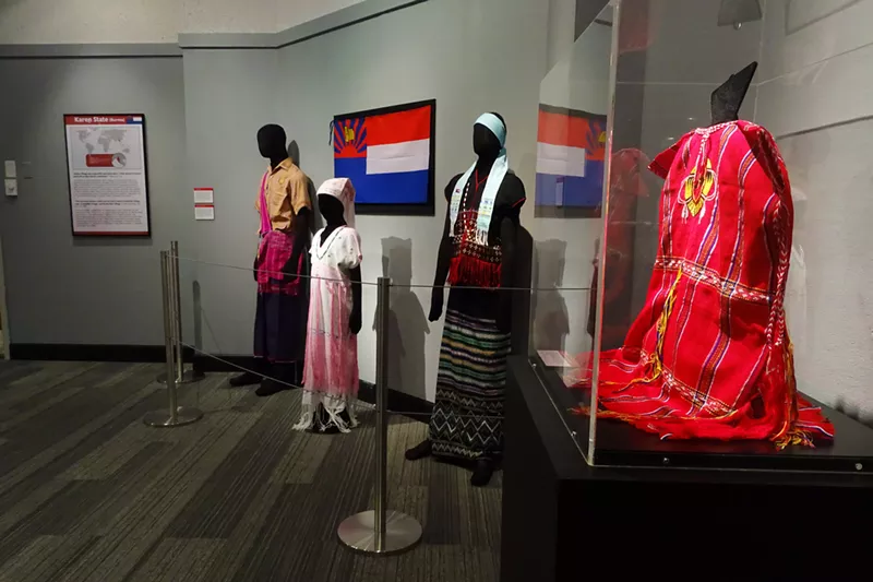 Image: Traditional clothing of the Karen people, an ethnic minority persecuted in Burma, at the Aurora History Museum; Aurora has welcomed hundreds of Burmese refugees, including Karen families.