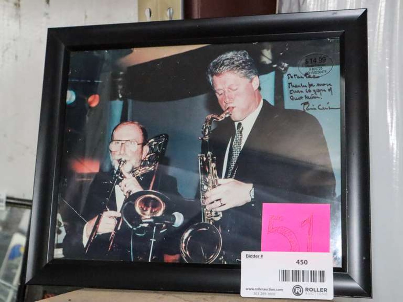 A signed and framed photo of former president Bill Clinton that used to hang in El Chapultepec is up for auction.