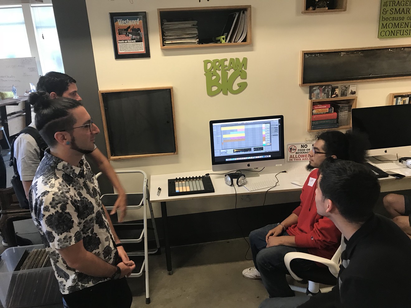 A couple of students did demos on the new computers for Dominic Lalli (from left) and Jeremy Salken of Big Gigantic.