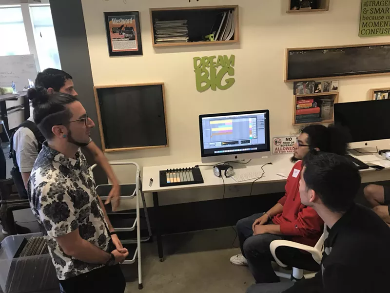 Image: A couple of students did demos on the new computers for Dominic Lalli (from left) and Jeremy Salken of Big Gigantic.